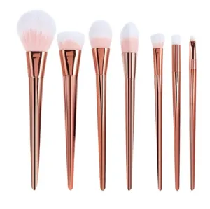 Professional 7-piece rose gold makeup brush set with diamond handles for flawless facial application.