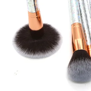 Detailed shot of professional makeup brush set with holographic handles and soft gradient bristles.