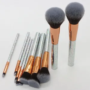 10-piece makeup brush set with holographic glitter handles, rose gold ferrules, and soft bristles.
