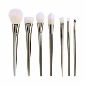 7-piece makeup brush set with diamond-cut metallic handles for professional daily use.