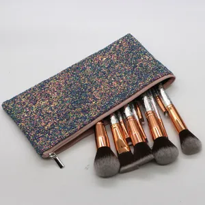 Detailed view of sparkly cosmetic makeup bag with professional beauty brushes set.