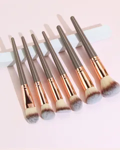 Professional makeup brush set detail with soft synthetic hair and rose gold handles.