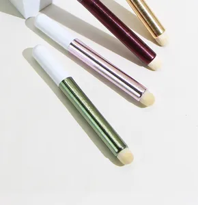 Detailed close-up view of portable cosmetic makeup brushes featuring colorful metallic handles.