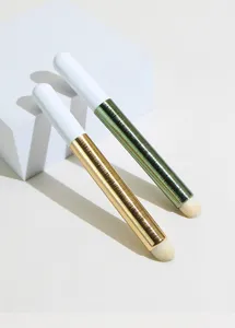 Professional makeup brush detail, round head lip brush and concealer brush with metallic handle.