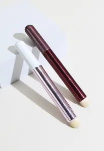 Portable dual color lip concealer makeup brushes with metallic finish and compact design.