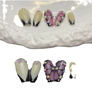 Handmade press-on nails set with nude French tips, silver glitter, and crystal rhinestones.