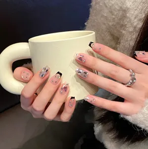 Handmade press-on nails detail shot, featuring stunning black French tips & crystal rhinestones.