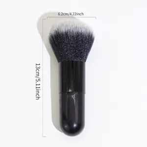 Close-up view of black kabuki powder makeup brush showcasing soft bristles and sleek handle.