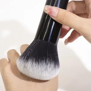 Large black makeup powder brush detail showing soft fluffy bristles and handle design for flawless face.