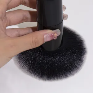 Black large fluffy makeup brush for loose powder and foundation, soft synthetic bristles.