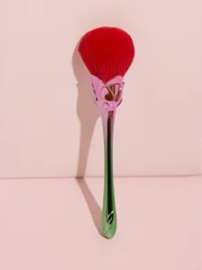 Gradient rose makeup brush detail view, featuring soft red bristles and metal handle.