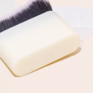 Flat foundation makeup brush with dense wave bristles and white handle for liquid makeup use