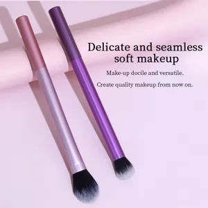 Detailed close-up shot of two gradient purple and pink makeup brushes with soft bristles.