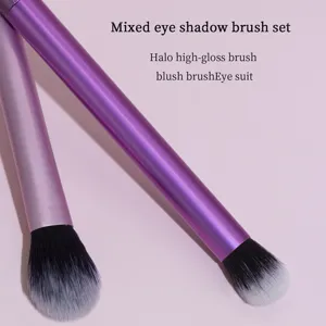 Pink handle makeup brush detail showing soft black and white gradient bristles for eye shadow.