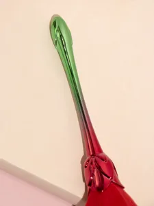 Rose flower makeup brush detail, gradient metallic handle and soft red bristles for use.
