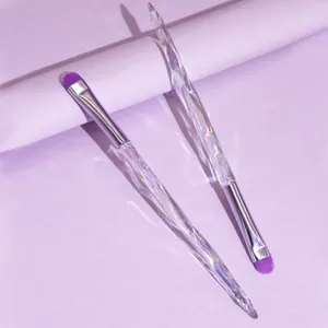 Crystal handle eyeshadow brush detail, soft purple bristle makeup tool close up view.