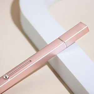 Rose gold retractable lip brush detail shot, professional cosmetic makeup tool for precise application.