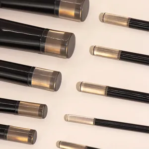 Mini makeup brush detail view showing black handles and clear crystal protective caps