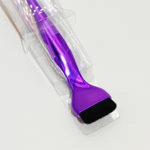 Detail view of the purple flat foundation brush with soft bristles and clear plastic packaging.