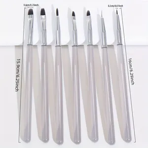 Detail view of professional acrylic nail art brushes set with clear handles and fine tips.