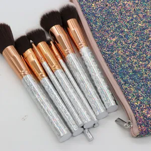 Detailed view of glitter makeup brush set handles and soft bristles with sparkle cosmetic pouch.