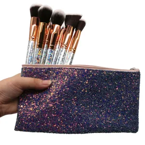 Detailed view of sparkling makeup brush set with glitter handles and a matching cosmetic pouch.