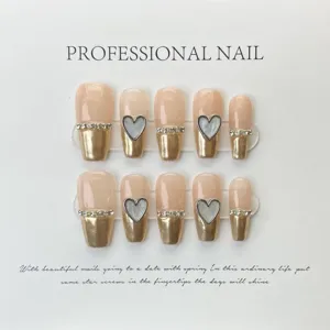 Uñas postizas hechas a mano nude con puntas doradas y pedrería diseño elegante set de 10