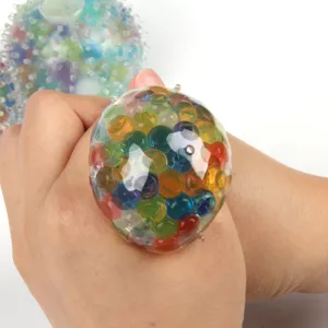 Close-up detail view of the colorful stress relief bead ball squeezed by hand for fun.
