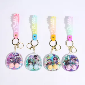 Cute mini water game console keychain with doll figures, colorful silicone strap, and metal rings.