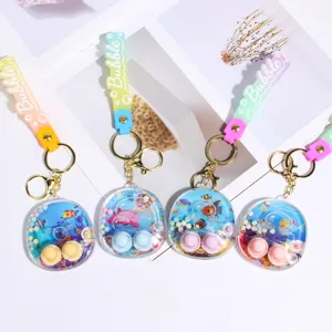 Cute water game machine keychain pendant with colorful silicone strap and clear shell.