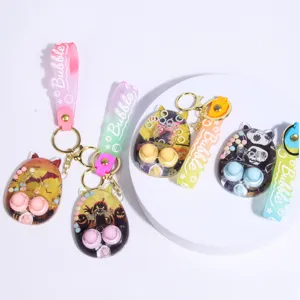 Cute Halloween water game keychain pendant with colorful silicone strap and portable design.