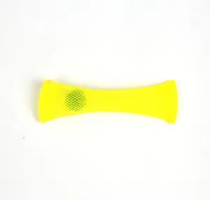 Close-up detail of yellow mesh squeeze toy with green marble inside for stress relief.