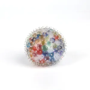 Translucent TPR rainbow sensory fidget squeeze ball with colorful beads for stress relief.