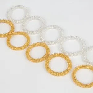 Vue de détail de bagues de massage de décompression sensorielle en métal or et argent.