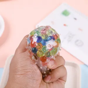 Detailed close-up of a colorful rainbow squeeze stress ball with water beads inside.