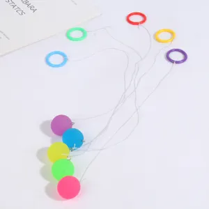 Children nostalgic toy elastic bouncing ball with string and colorful finger rings for fun.