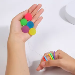 Colorful string bouncing balls detail view showing translucent colorful balls with finger rings.