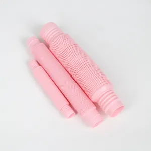 Close-up detail shot of pink plastic expandable pop tubes, showcasing flexible corrugated design.