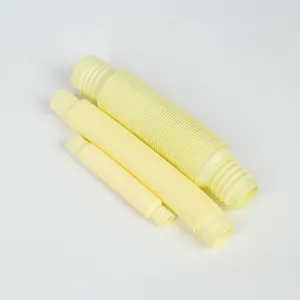 Detail shot of yellow plastic stretch tubes, flexible pop tube sensory fidget toys for adults.