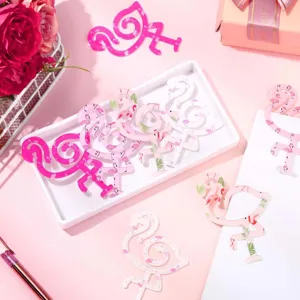 Detailed close-up of colorful floral acrylic flamingo bookmarks displayed on a white tray.