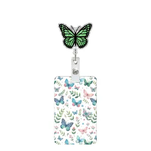 Close-up of green glitter butterfly retractable badge reel and floral ID card holder detail.