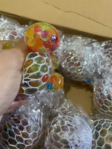 Mesh grape stress relief toy with colorful beads for hand squeezing and relaxation.