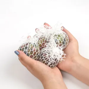 Detail shot showing a set of four colorful mesh squeeze grape balls held in hands, stress toy.