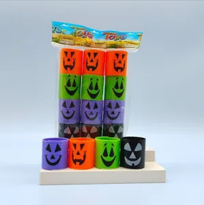 Mini plastic spring rainbow toys with cute Halloween pumpkin face design, perfect for party favors.