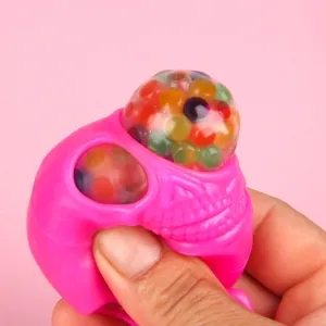 Pink skull squeeze toy detail showing colorful water beads and soft texture clearly.