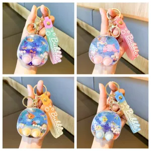 Cute cartoon liquid water game keychain, clear shell with floating marine toys and colorful strap.