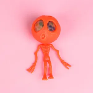 Orange alien skeleton squeeze toy with colorful gel bead eyes for Halloween stress relief.