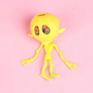 Detail view of yellow alien squeeze toy, showing textured rubber body and colorful water beads.