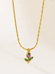 Close-up of a delicate floral pendant necklace with purple and green stones, exquisite chain detail.