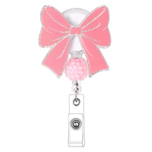 Pink bow badge reel with glitter finish, cute beaded retractable ID badge holder for office school.